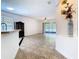 View from the kitchen into the living room with sliding doors to outdoor patio at 6843 Cherry Grove Cir, Orlando, FL 32809