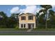 Charming two-story home with yellow siding, dark shutters, and well-maintained landscaping at 7183 Rosy Sky Ave, Orlando, FL 32829