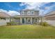 Well-maintained backyard featuring a covered patio, lush lawn, and privacy fence at 8230 Corkfield Ave, Orlando, FL 32832