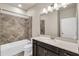 Modern bathroom with tiled shower, white countertop vanity, and decorative lighting fixture at 8230 Corkfield Ave, Orlando, FL 32832