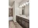 Bathroom featuring double vanity, quartz countertop, dark wood cabinets, and modern tiled shower with tub at 8230 Corkfield Ave, Orlando, FL 32832