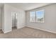 A neutral carpeted bedroom with a closet and bright windows at 8230 Corkfield Ave, Orlando, FL 32832