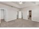 Bedroom featuring a tray ceiling, carpet flooring, neutral walls and multiple closets with access to the bathroom at 8230 Corkfield Ave, Orlando, FL 32832
