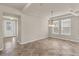 Bright dining room features a modern chandelier, tile flooring, and ample natural light at 8230 Corkfield Ave, Orlando, FL 32832