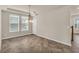 Open dining room featuring tile floors, tray ceiling, modern chandelier, and large windows at 8230 Corkfield Ave, Orlando, FL 32832