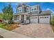 Beautiful two-story home with a three car garage, manicured lawn and brick paver driveway at 8230 Corkfield Ave, Orlando, FL 32832