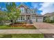 Charming two-story home with a welcoming front porch, manicured lawn and three car garage at 8230 Corkfield Ave, Orlando, FL 32832