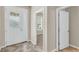 Bright foyer featuring tile flooring, decorative glass door, and an open view into other rooms at 8230 Corkfield Ave, Orlando, FL 32832