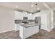 Bright kitchen featuring white cabinets, stainless steel appliances, and a center island at 8230 Corkfield Ave, Orlando, FL 32832