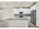 Bright kitchen featuring white cabinets, stainless steel appliances, and a center island at 8230 Corkfield Ave, Orlando, FL 32832