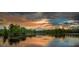 Scenic view of the lake with a golden reflection of the colorful, dramatic sky at 8230 Corkfield Ave, Orlando, FL 32832