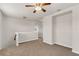 Open loft area featuring neutral walls, carpet flooring, a ceiling fan, and natural lighting from the nearby window at 8230 Corkfield Ave, Orlando, FL 32832