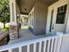 Inviting front porch with stone accents on the columns and a view of the neighborhood at 8230 Corkfield Ave, Orlando, FL 32832