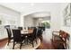 This dining area features hardwood floors, an elegant chandelier, and views of the outdoor pool area at 8418 Via Bella Notte, Orlando, FL 32836