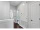 Hallway featuring dark hardwood floors, white trim, doors leading to bedrooms and bathrooms, and a utility closet at 8418 Via Bella Notte, Orlando, FL 32836