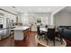 Bright kitchen with white cabinetry, a large center island, and hardwood floors adjacent dining area at 8418 Via Bella Notte, Orlando, FL 32836