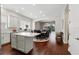 Open-concept kitchen with white cabinets and island seating with a dining area at 8418 Via Bella Notte, Orlando, FL 32836