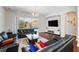 Bright living room featuring hardwood floors, comfortable seating, and a scenic view of the outdoor pool at 8418 Via Bella Notte, Orlando, FL 32836