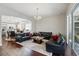 Open-concept living room connects to the dining and kitchen area, featuring hardwood floors and comfortable seating at 8418 Via Bella Notte, Orlando, FL 32836