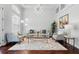 Spacious living room featuring hardwood floors, neutral furniture, and a modern light fixture at 8418 Via Bella Notte, Orlando, FL 32836