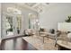 Sunlit living room featuring stylish furniture, dark floors, and an elegant lighting at 8418 Via Bella Notte, Orlando, FL 32836