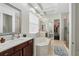 Bright main bathroom featuring dual sinks, a jacuzzi style bathtub, walk-in closet and glass enclosed shower at 8418 Via Bella Notte, Orlando, FL 32836