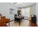 Well-lit office with dark wooden desk and a bright window at 8418 Via Bella Notte, Orlando, FL 32836