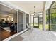 Covered outdoor patio with pavers, ceiling fans, and view into home and backyard at 8418 Via Bella Notte, Orlando, FL 32836