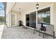 Covered outdoor patio with pavers, a grill, ceiling fans, and view of the pool at 8418 Via Bella Notte, Orlando, FL 32836