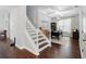 Staircase with white railings and wooden steps, leading to a home office with coffered ceiling at 8418 Via Bella Notte, Orlando, FL 32836