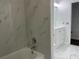 Bathroom featuring a shower/tub combo with marble tile and modern vanity at 909 San Paulo Way, Kissimmee, FL 34758