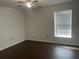 Bedroom featuring a ceiling fan, window with blinds, and dark wood flooring at 909 San Paulo Way, Kissimmee, FL 34758