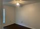 Bedroom featuring a ceiling fan, window with blinds, and dark wood flooring at 909 San Paulo Way, Kissimmee, FL 34758
