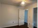 Bedroom featuring a ceiling fan, doorway, and dark wood flooring at 909 San Paulo Way, Kissimmee, FL 34758