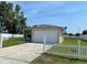 Single-story home with an attached two-car garage, visible driveway, and manicured lawn at 909 San Paulo Way, Kissimmee, FL 34758