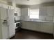 Kitchen featuring white cabinets, stainless steel appliances, and dark flooring at 909 San Paulo Way, Kissimmee, FL 34758