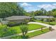 This aerial view showcases a well-maintained lawn, mature trees, and neat landscaping surrounding the home at 1017 Manchester Cir, Winter Park, FL 32792