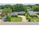 Aerial view showcases this cozy single-story home with a circular driveway, lush yard, and mature trees in a serene neighborhood at 1017 Manchester Cir, Winter Park, FL 32792