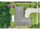 Aerial view of the property showcasing the house, roof, driveway, landscaping, and surrounding trees at 1017 Manchester Cir, Winter Park, FL 32792