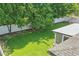 Well-kept backyard with healthy grass, a white fence providing privacy, and mature trees adding natural beauty at 1017 Manchester Cir, Winter Park, FL 32792