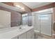 Well-lit bathroom with shower, vanity, and skylight at 1017 Manchester Cir, Winter Park, FL 32792