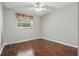 Inviting bedroom features hardwood floors, neutral walls, and lots of light at 1017 Manchester Cir, Winter Park, FL 32792