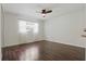 This bright bedroom features a ceiling fan, wood floors, and a large window at 1017 Manchester Cir, Winter Park, FL 32792