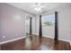 This bedroom has wood floors, a ceiling fan, and a large window that lets in plenty of natural light at 1017 Manchester Cir, Winter Park, FL 32792