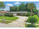 Lovely single-story home with lush lawn and landscaping, complemented by a circular driveway and two car garage, showing great curb appeal at 1017 Manchester Cir, Winter Park, FL 32792
