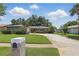 Charming single-story home with a manicured lawn, verdant landscaping, and a welcoming circular driveway offering curb appeal and character at 1017 Manchester Cir, Winter Park, FL 32792