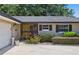 Inviting home exterior featuring a vibrant yellow door, well-kept landscaping, and a cozy, welcoming entrance at 1017 Manchester Cir, Winter Park, FL 32792