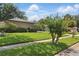 Well-manicured front yard with lush green grass and neatly trimmed bushes in a peaceful neighborhood at 1017 Manchester Cir, Winter Park, FL 32792