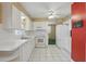 Spacious kitchen featuring white appliances, cabinets, and tile flooring that extends into adjacent living spaces at 1017 Manchester Cir, Winter Park, FL 32792