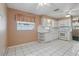 Bright kitchen featuring white appliances, cabinets, tile flooring, and a window for natural light at 1017 Manchester Cir, Winter Park, FL 32792